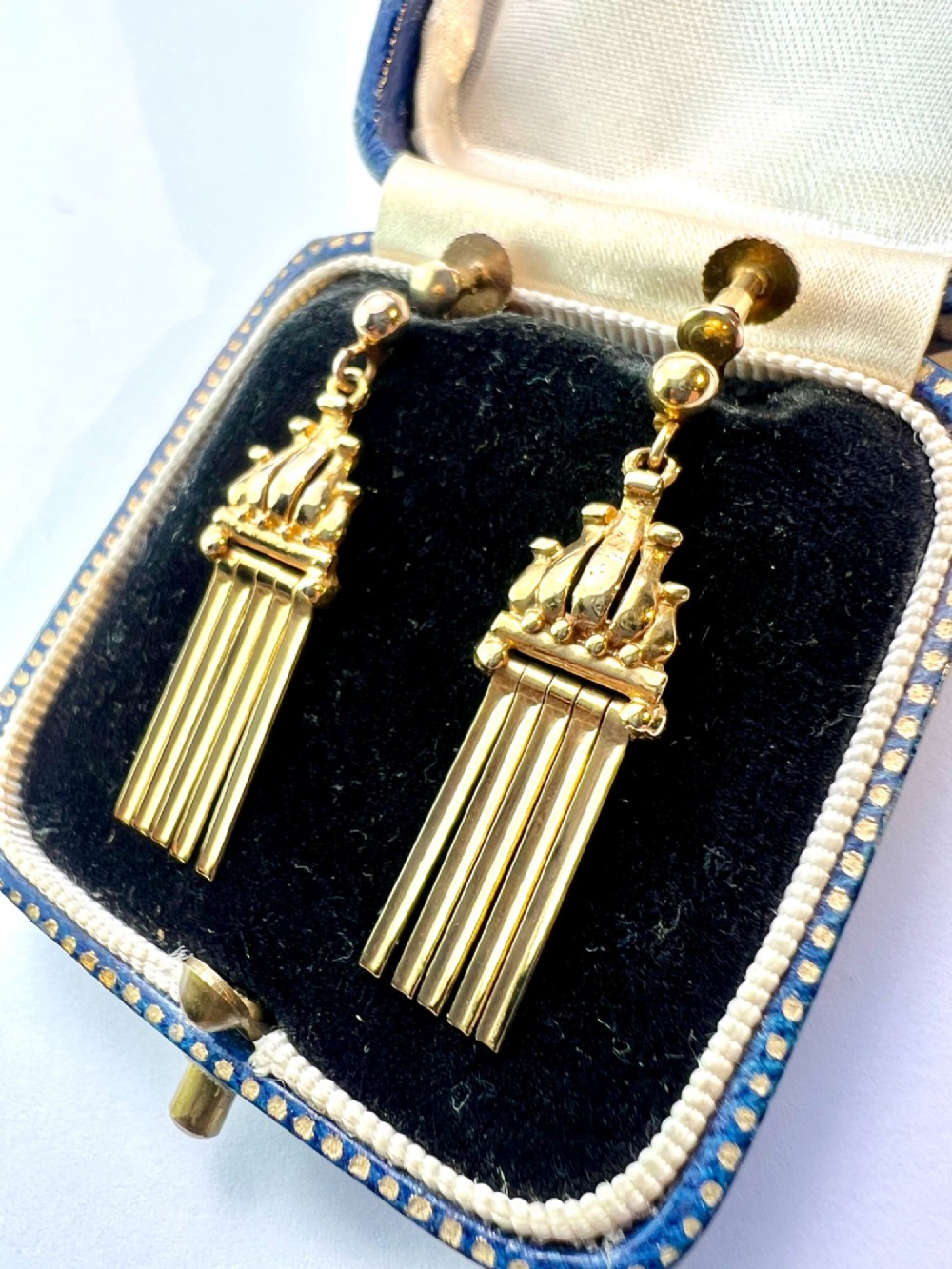 A pair of vintage 9ct yellow gold drop earrings featuring articulated fringe tassels suspended from decorative caps with screw-back fastenings. View II