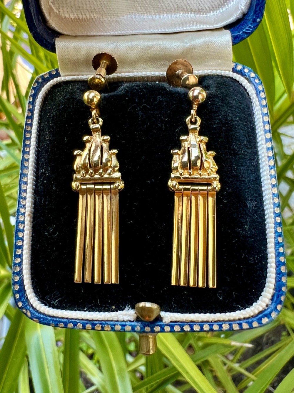 A pair of vintage 9ct yellow gold drop earrings featuring articulated fringe tassels suspended from decorative caps with screw-back fastenings. View VII