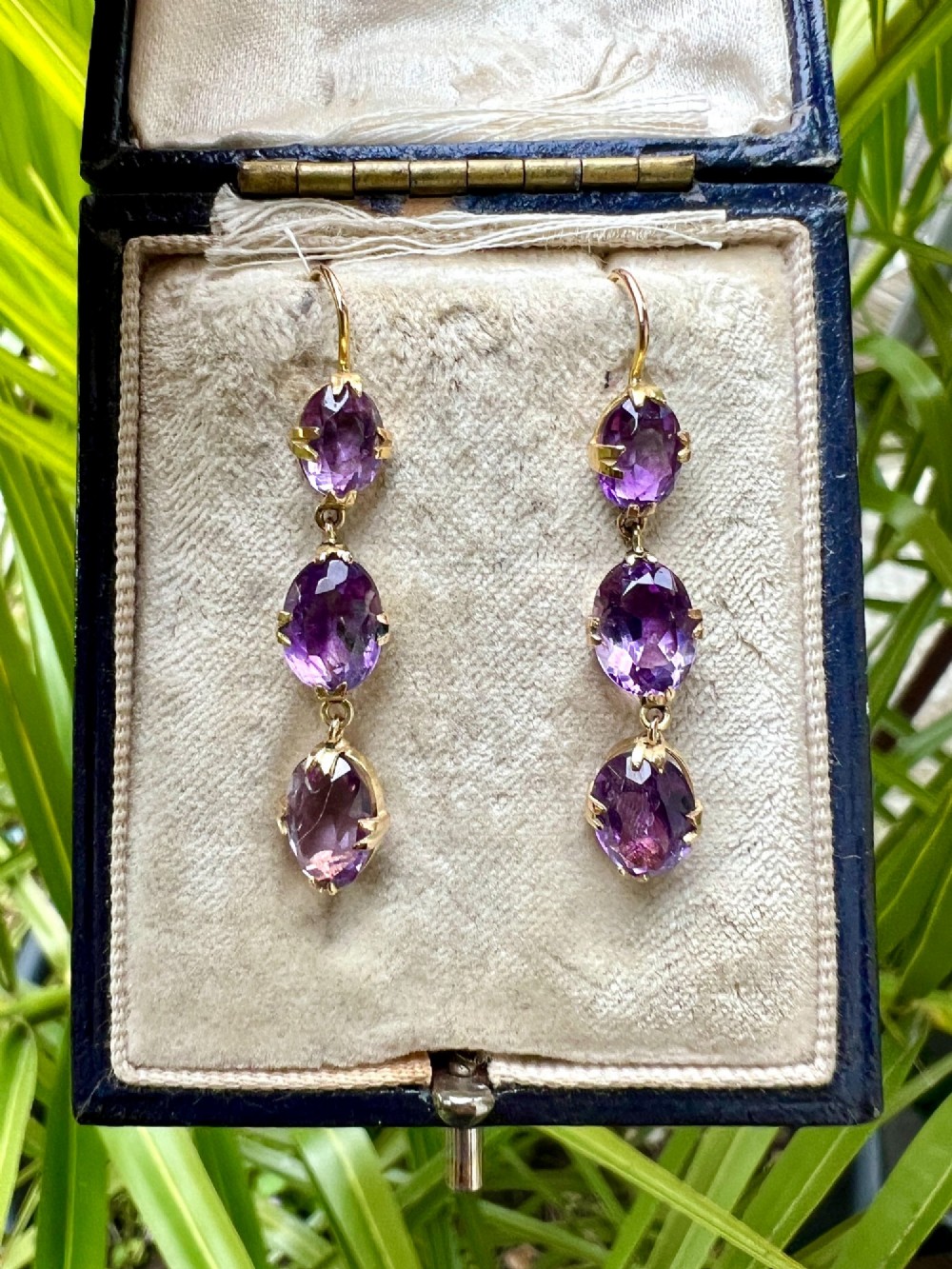 A pair of antique 9ct yellow gold drop earrings, each set with three articulated oval faceted purple amethysts in claw mounts. View VIII