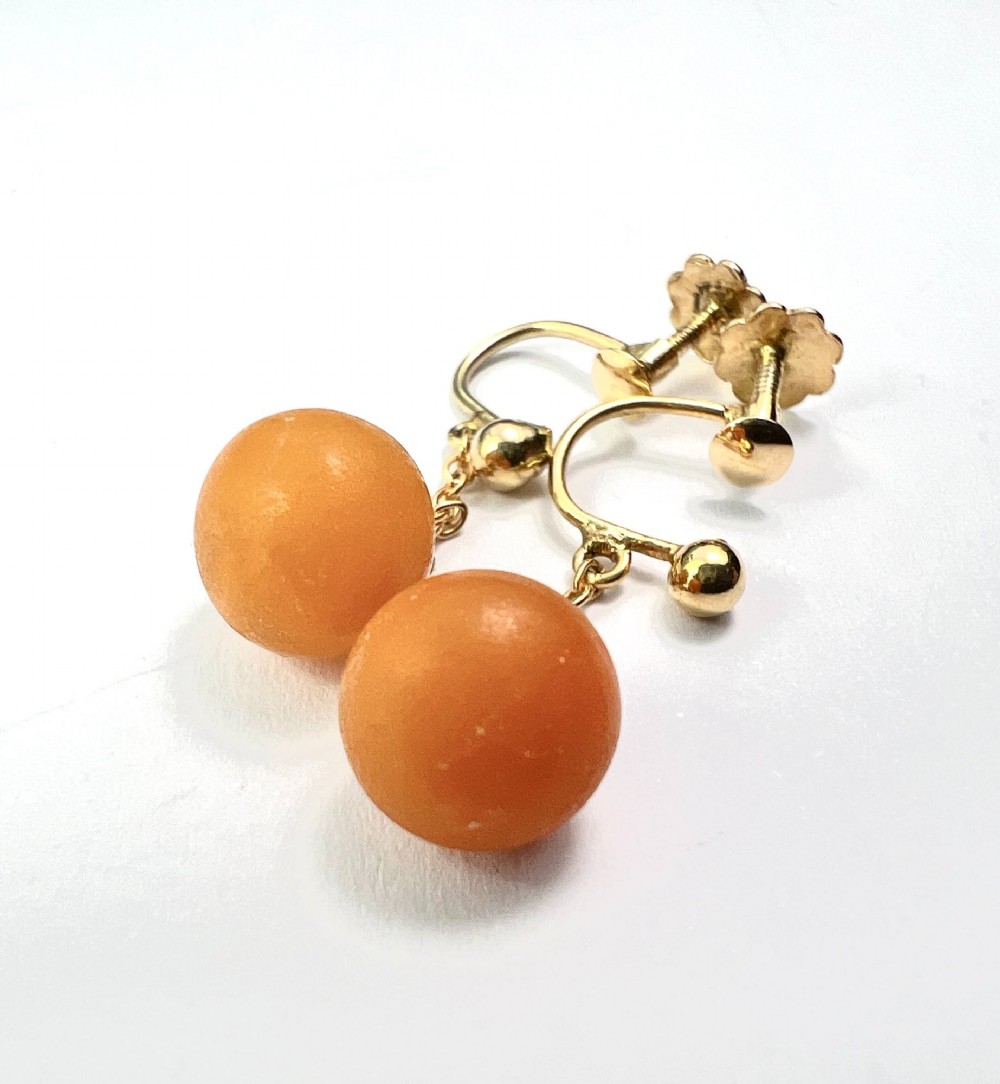 A pair of Edwardian 9ct gold drop earrings featuring spherical amber beads suspended from fine link chains. View III