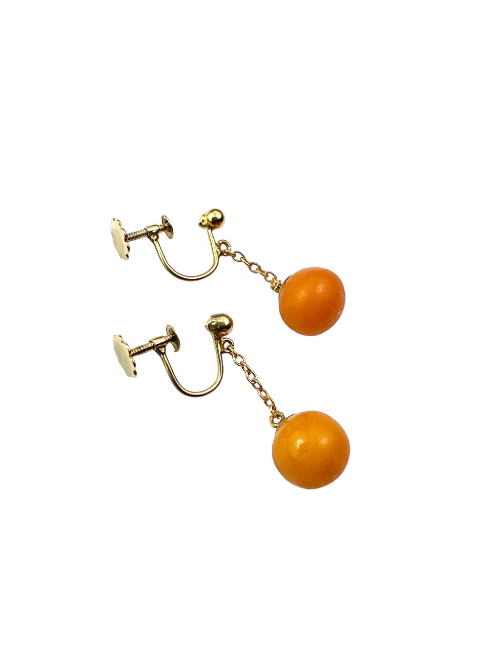 A pair of Edwardian 9ct gold drop earrings featuring spherical amber beads suspended from fine link chains. View V