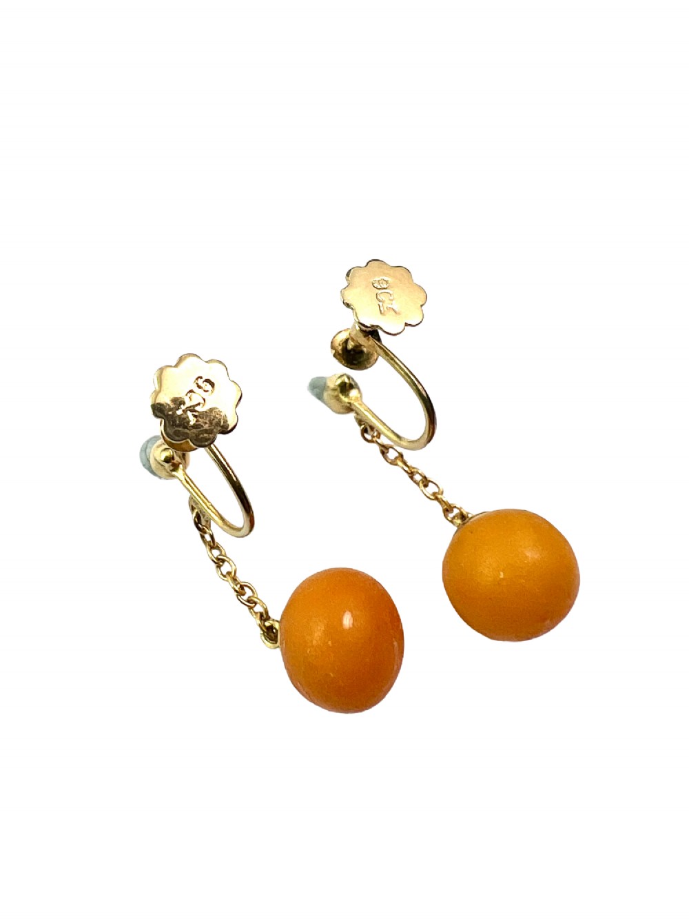 A pair of Edwardian 9ct gold drop earrings featuring spherical amber beads suspended from fine link chains. View VI