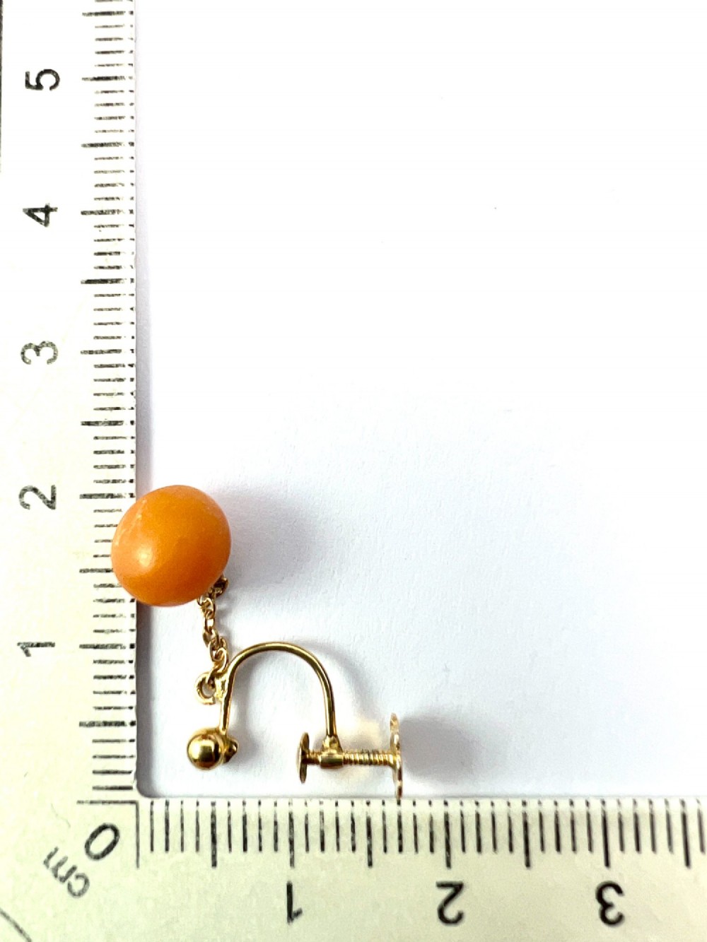 A pair of Edwardian 9ct gold drop earrings featuring spherical amber beads suspended from fine link chains. View VII