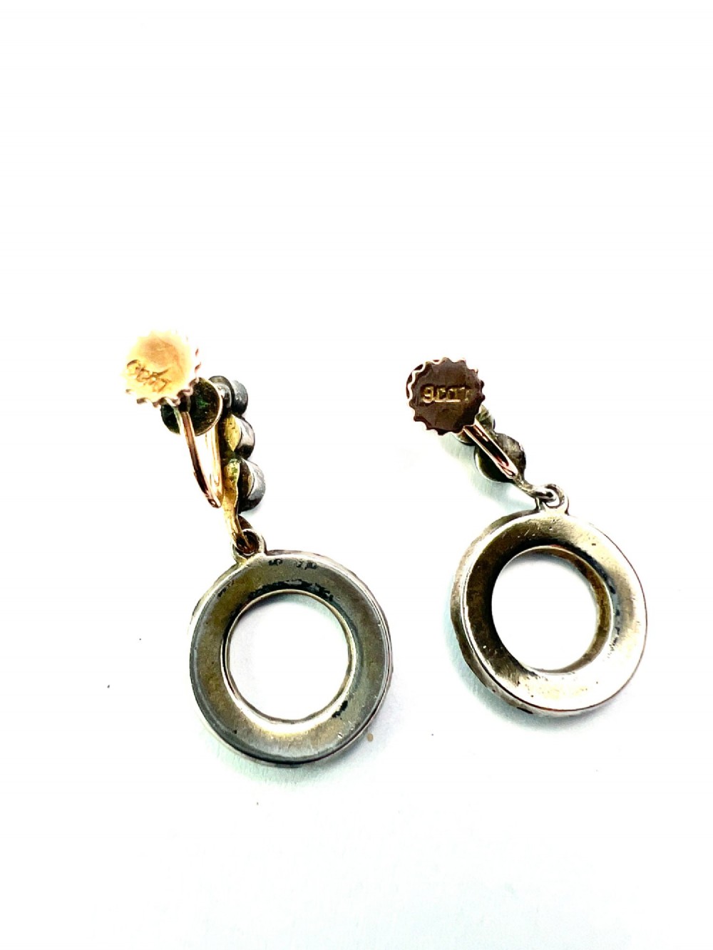A pair of Victorian gold and silver drop earrings featuring circular open-hoop motifs set with small turquoise cabochons. View V
