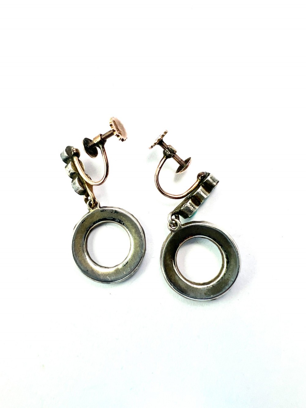 A pair of Victorian gold and silver drop earrings featuring circular open-hoop motifs set with small turquoise cabochons. View VI