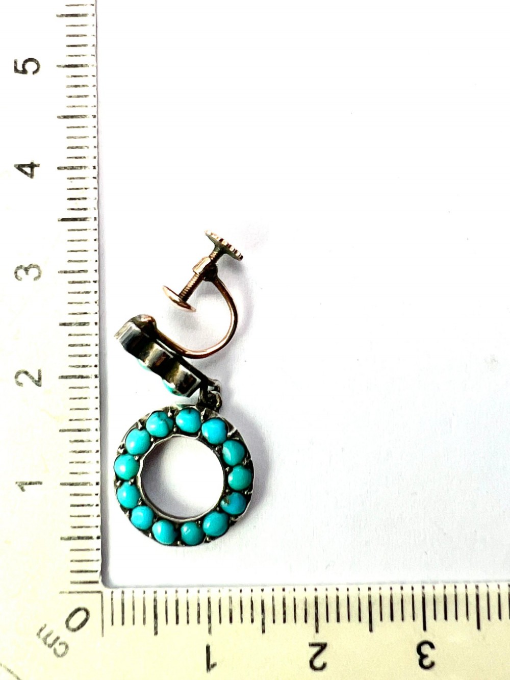 A pair of Victorian gold and silver drop earrings featuring circular open-hoop motifs set with small turquoise cabochons. View VII