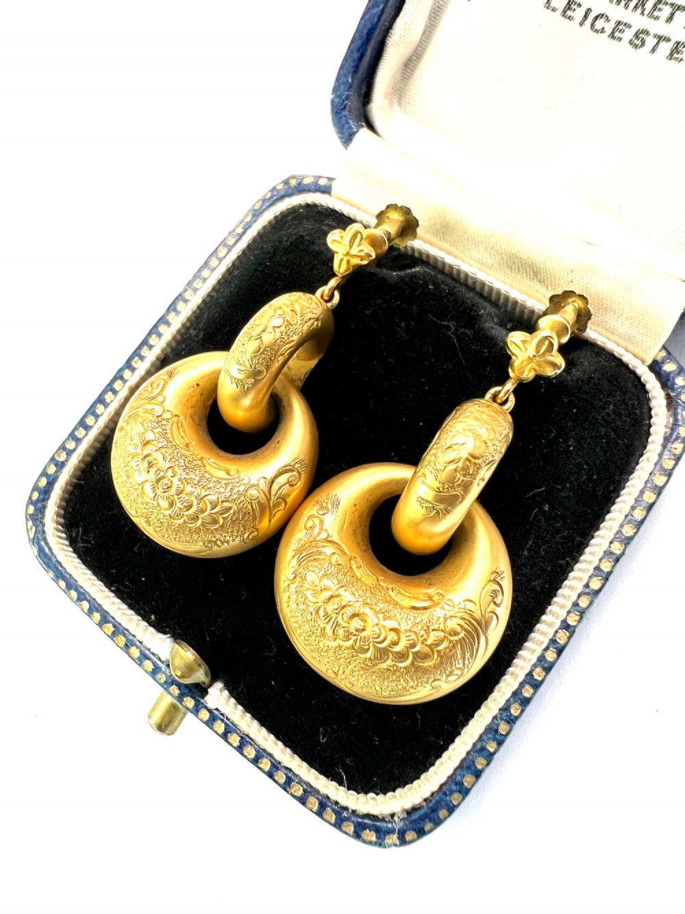 A pair of Victorian 15ct yellow gold drop earrings featuring floral engraving and interlocking circular hoops. View II
