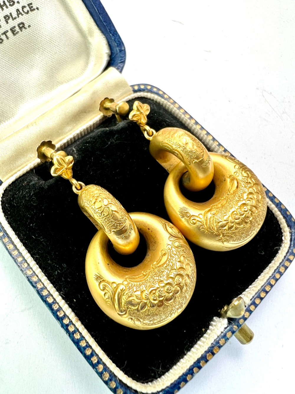 A pair of Victorian 15ct yellow gold drop earrings featuring floral engraving and interlocking circular hoops. View III