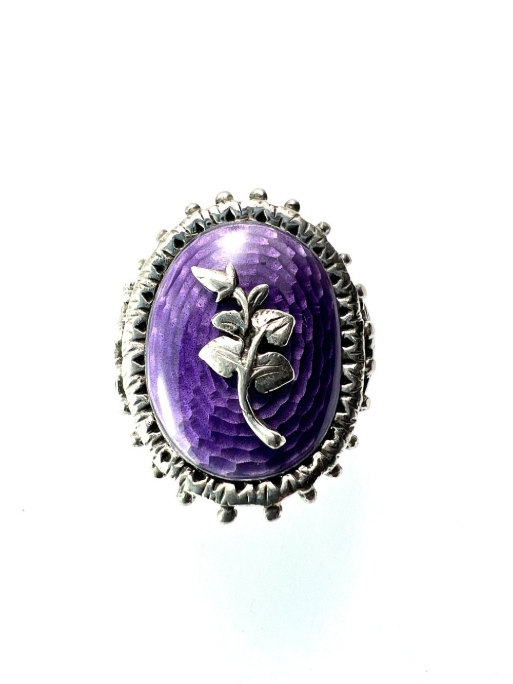 A matching silver jewellery set featuring purple guilloche enamel panels decorated with silver leaf motifs, including drop earrings, a ring, and an articulated link bracelet. View IV