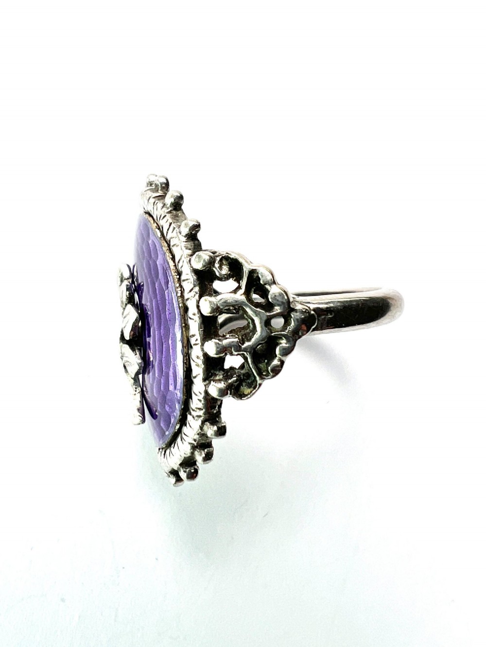 A matching silver jewellery set featuring purple guilloche enamel panels decorated with silver leaf motifs, including drop earrings, a ring, and an articulated link bracelet. View V