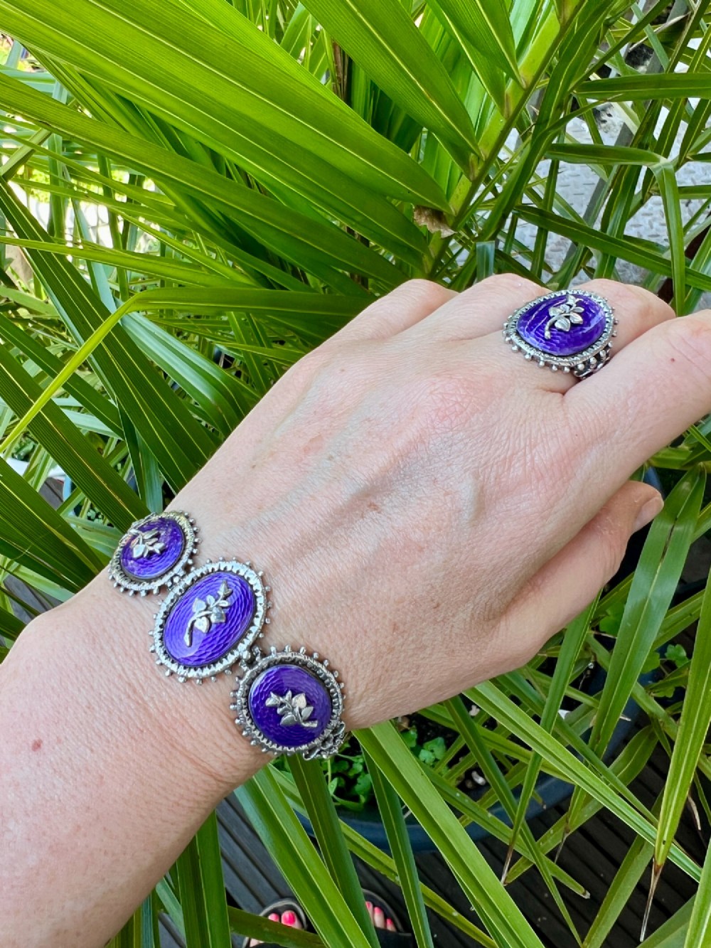 A matching silver jewellery set featuring purple guilloche enamel panels decorated with silver leaf motifs, including drop earrings, a ring, and an articulated link bracelet. View XI