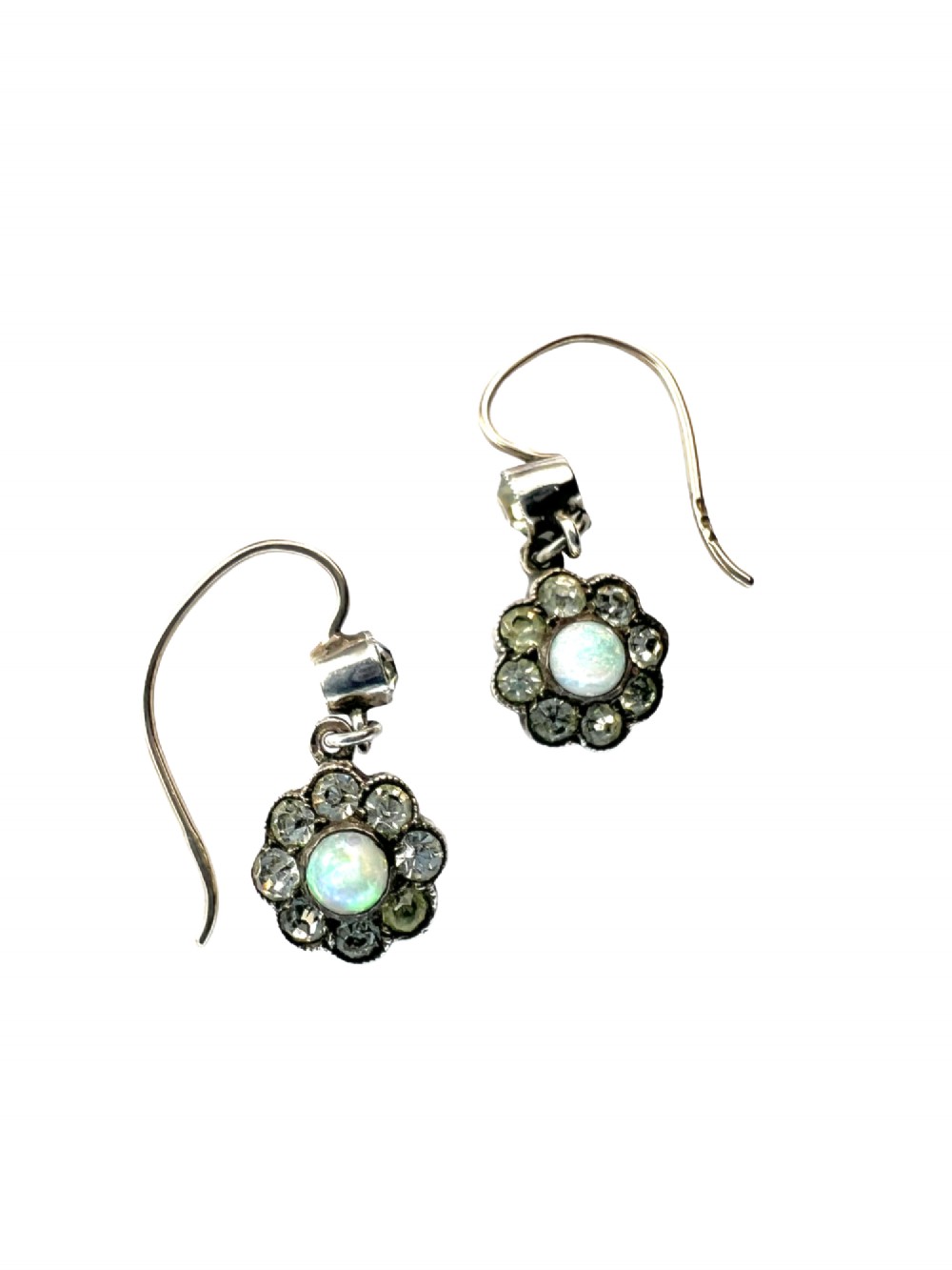 A pair of antique silver drop earrings featuring central opals surrounded by sparkling paste stones in floral cluster settings. View II