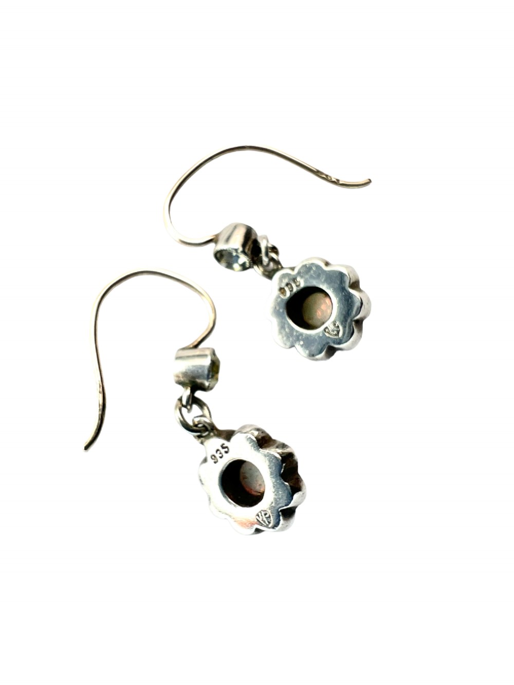 A pair of antique silver drop earrings featuring central opals surrounded by sparkling paste stones in floral cluster settings. View III