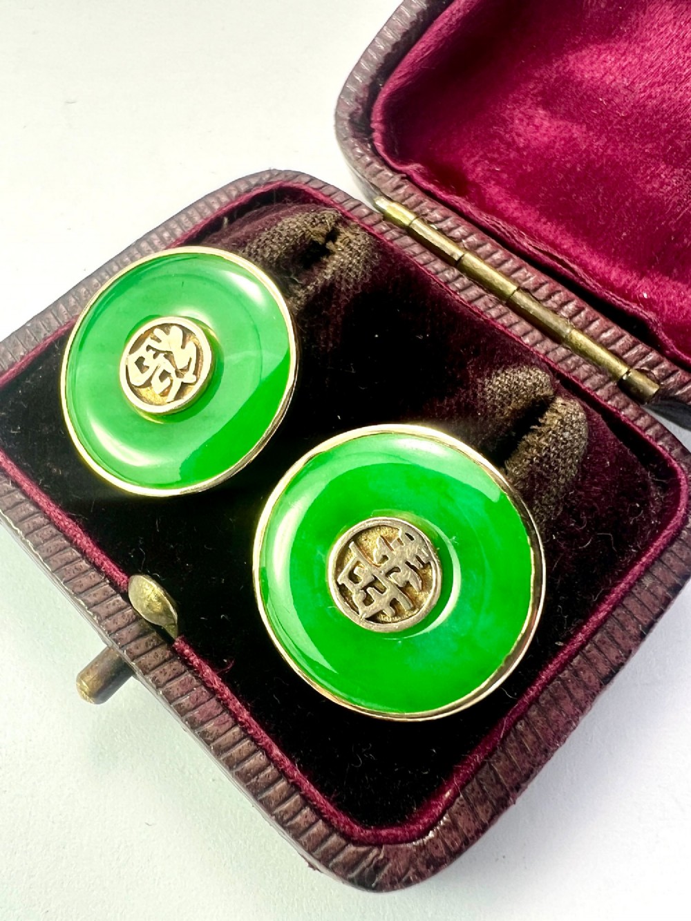 Pair of circular green jade torus stud earrings with central fourteen-carat gold character medallions. View III