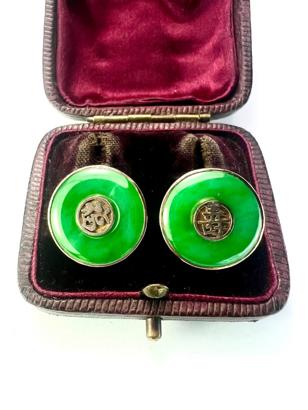 Pair of circular green jade torus stud earrings with central fourteen-carat gold character medallions. View IV