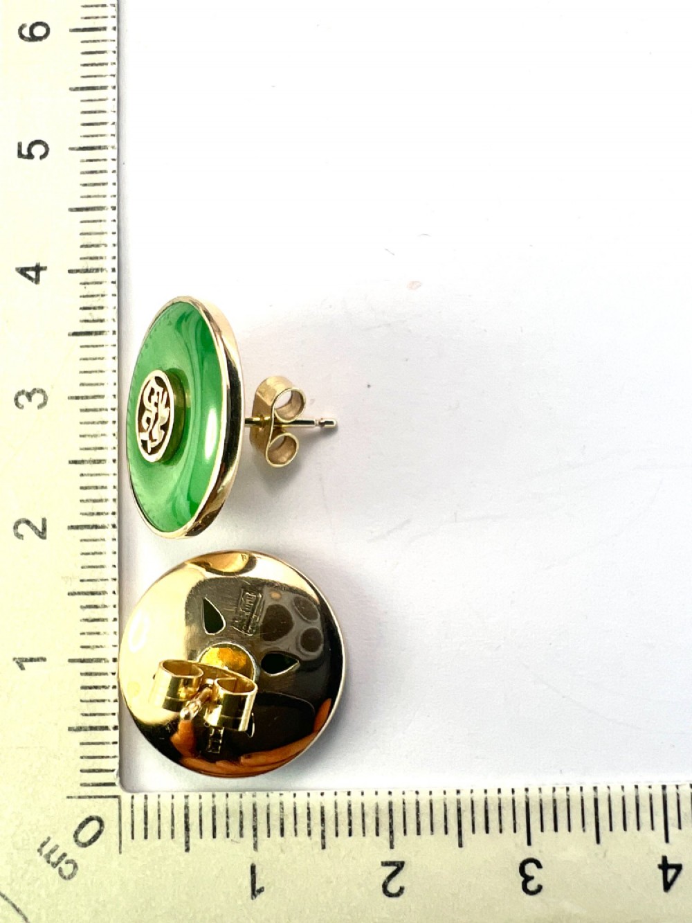 Pair of circular green jade torus stud earrings with central fourteen-carat gold character medallions. View VII
