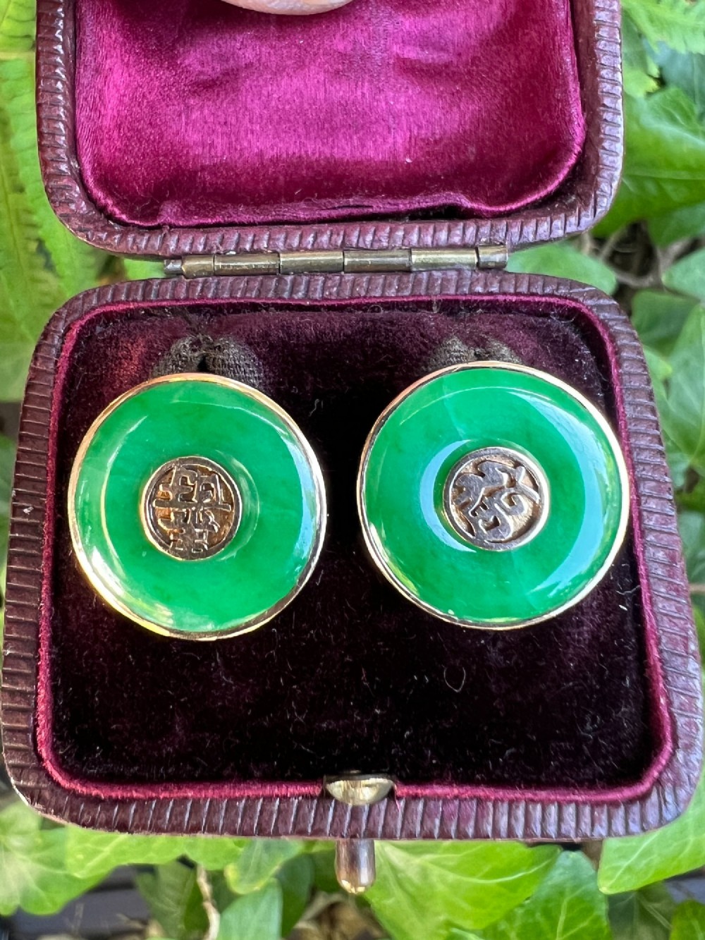 Pair of circular green jade torus stud earrings with central fourteen-carat gold character medallions. View IX