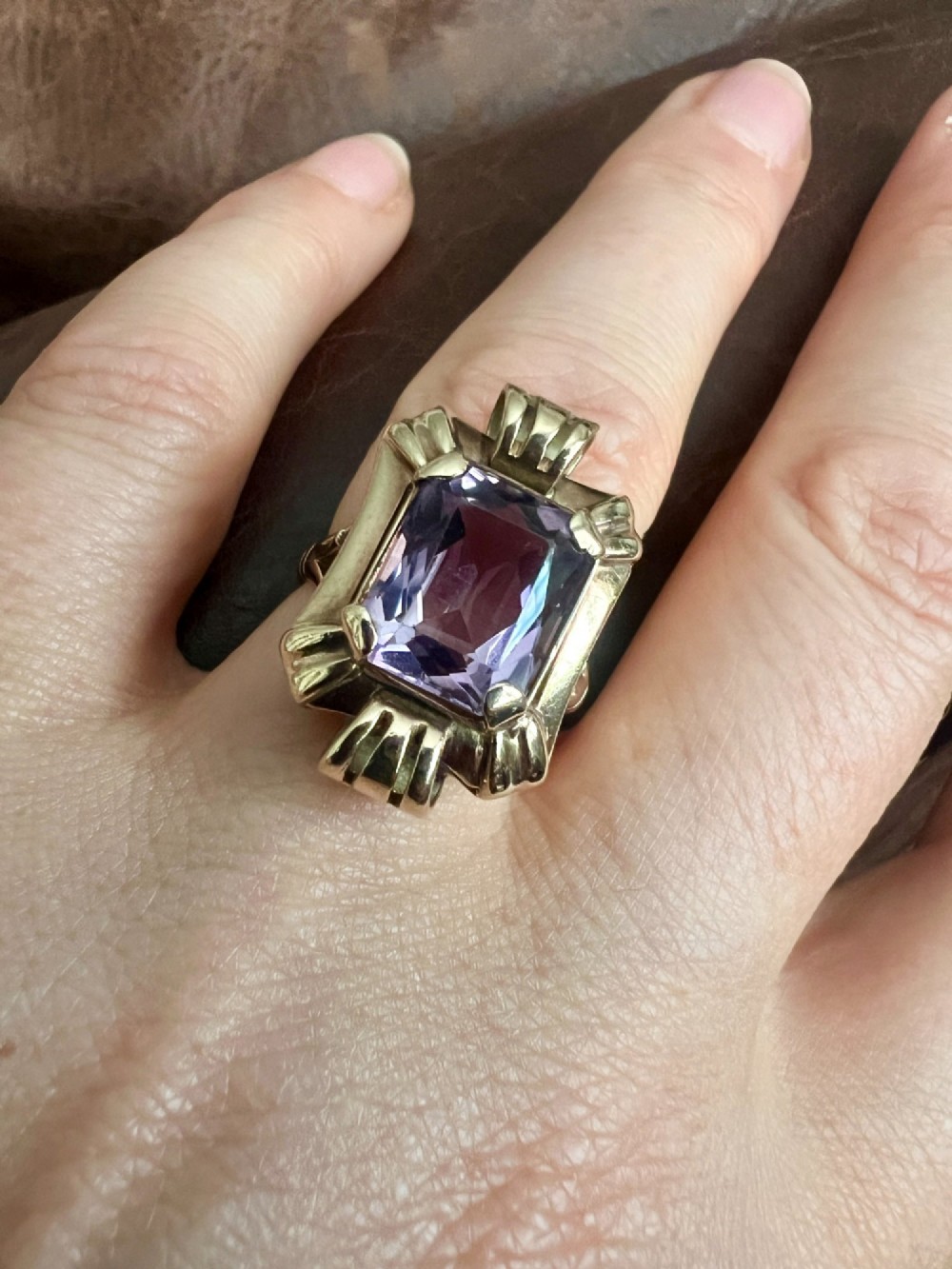 A pair of late Art Deco gold drop earrings featuring rectangular emerald-cut purple amethyst stones set within fluted geometric mounts. View IX