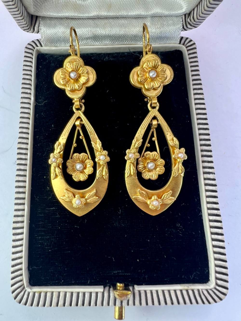 A pair of late Victorian yellow gold drop earrings featuring floral detailing and central pearl settings. View II