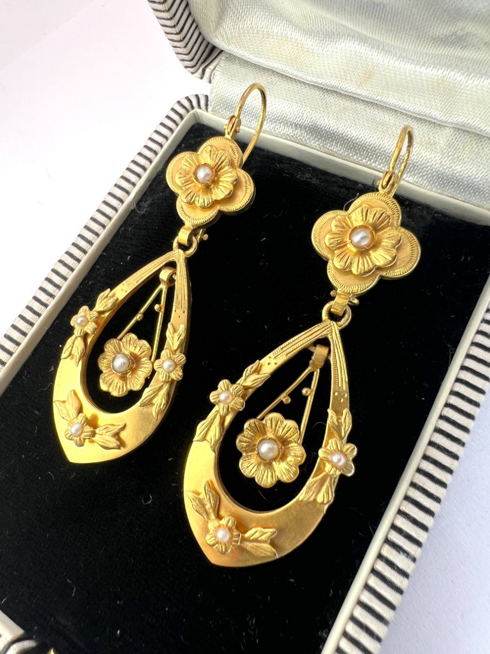 A pair of late Victorian yellow gold drop earrings featuring floral detailing and central pearl settings. View III
