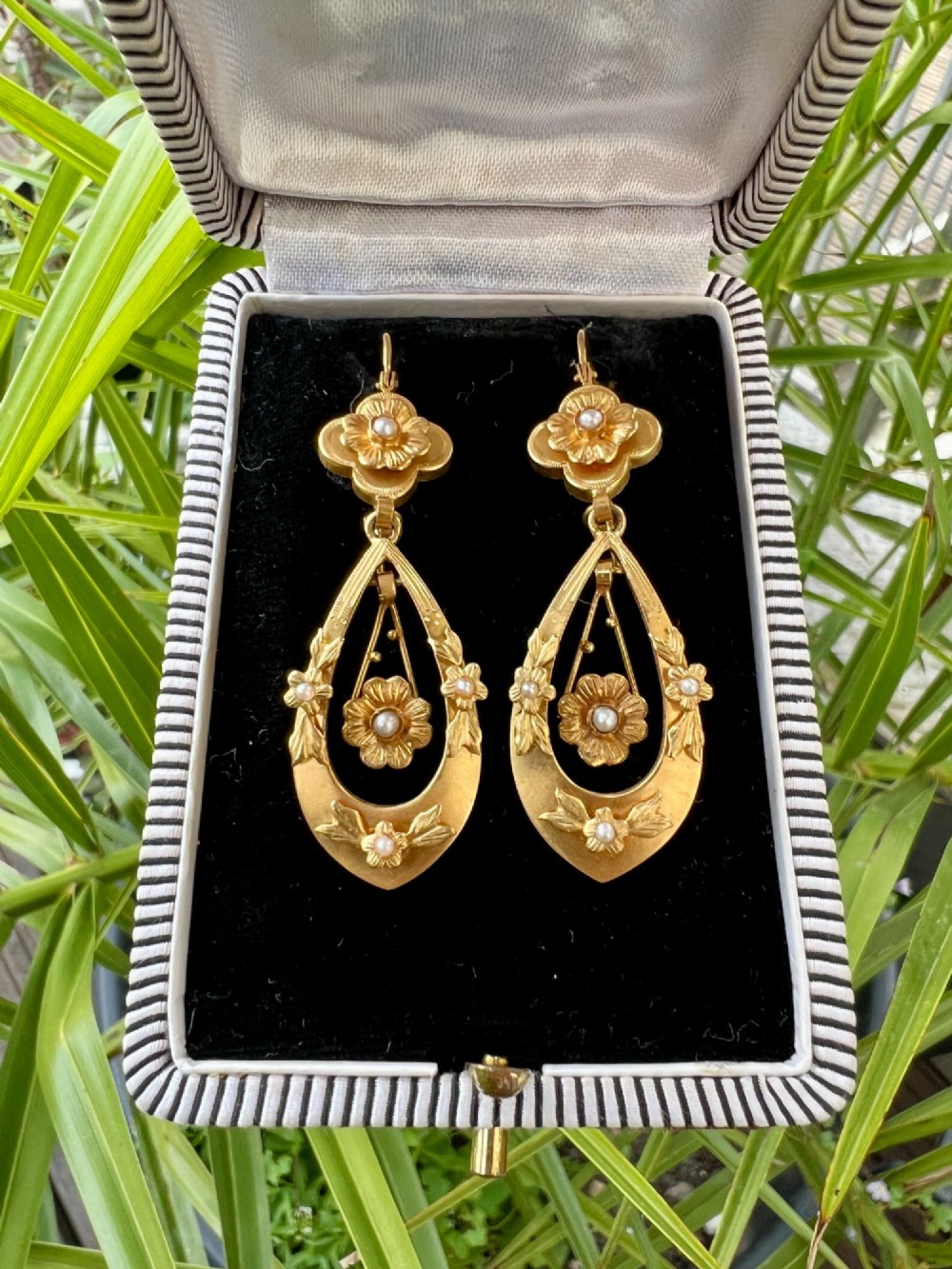 A pair of late Victorian yellow gold drop earrings featuring floral detailing and central pearl settings. View VIII
