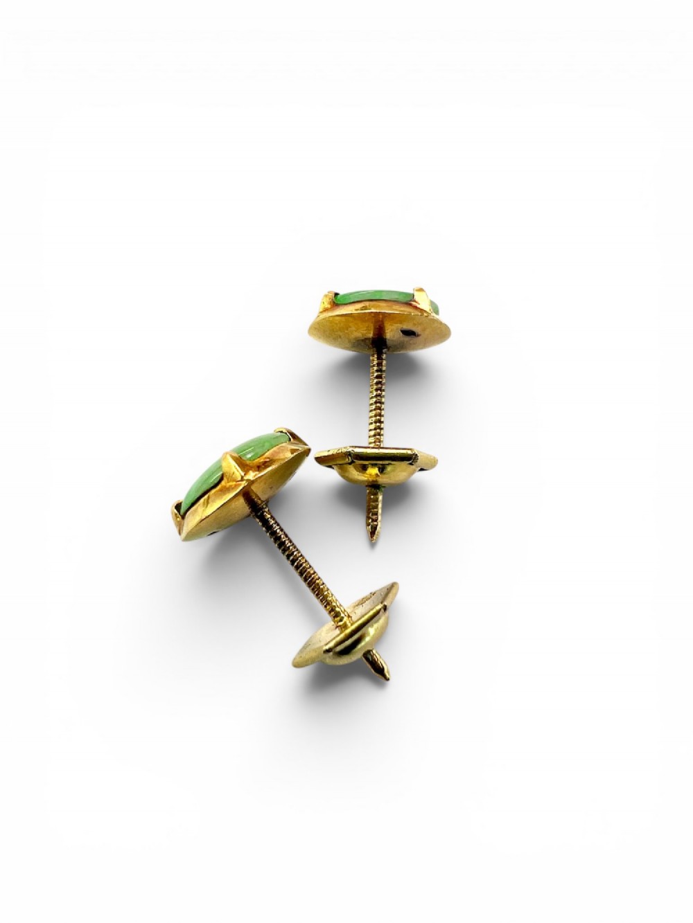 A pair of circular pale green jadeite cabochon stud earrings held in yellow gold claw settings. View II