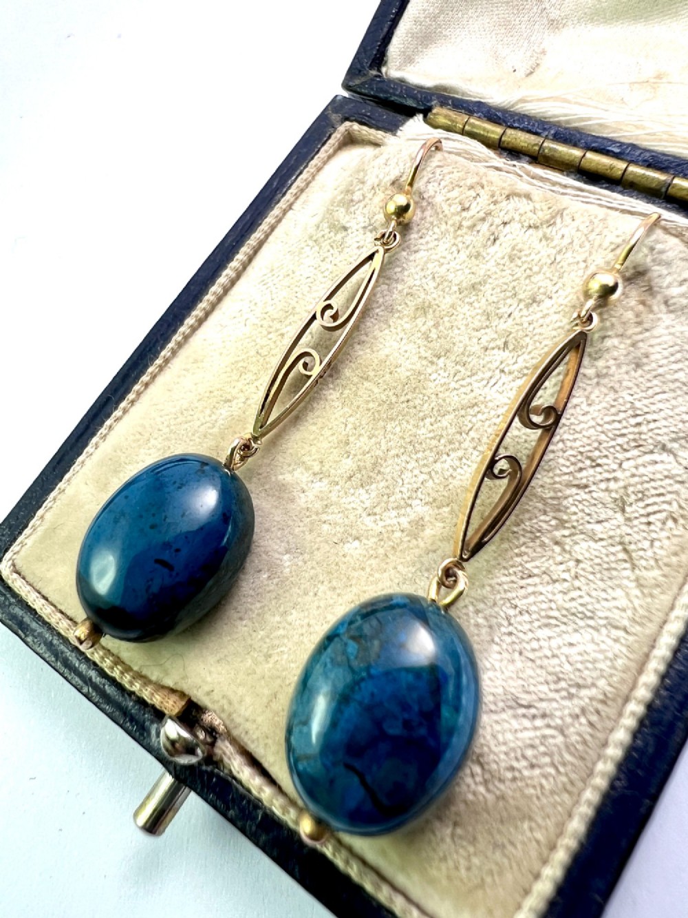 A pair of Edwardian yellow gold drop earrings featuring openwork scrollwork links suspended above oval blue apatite cabochon drops. View II