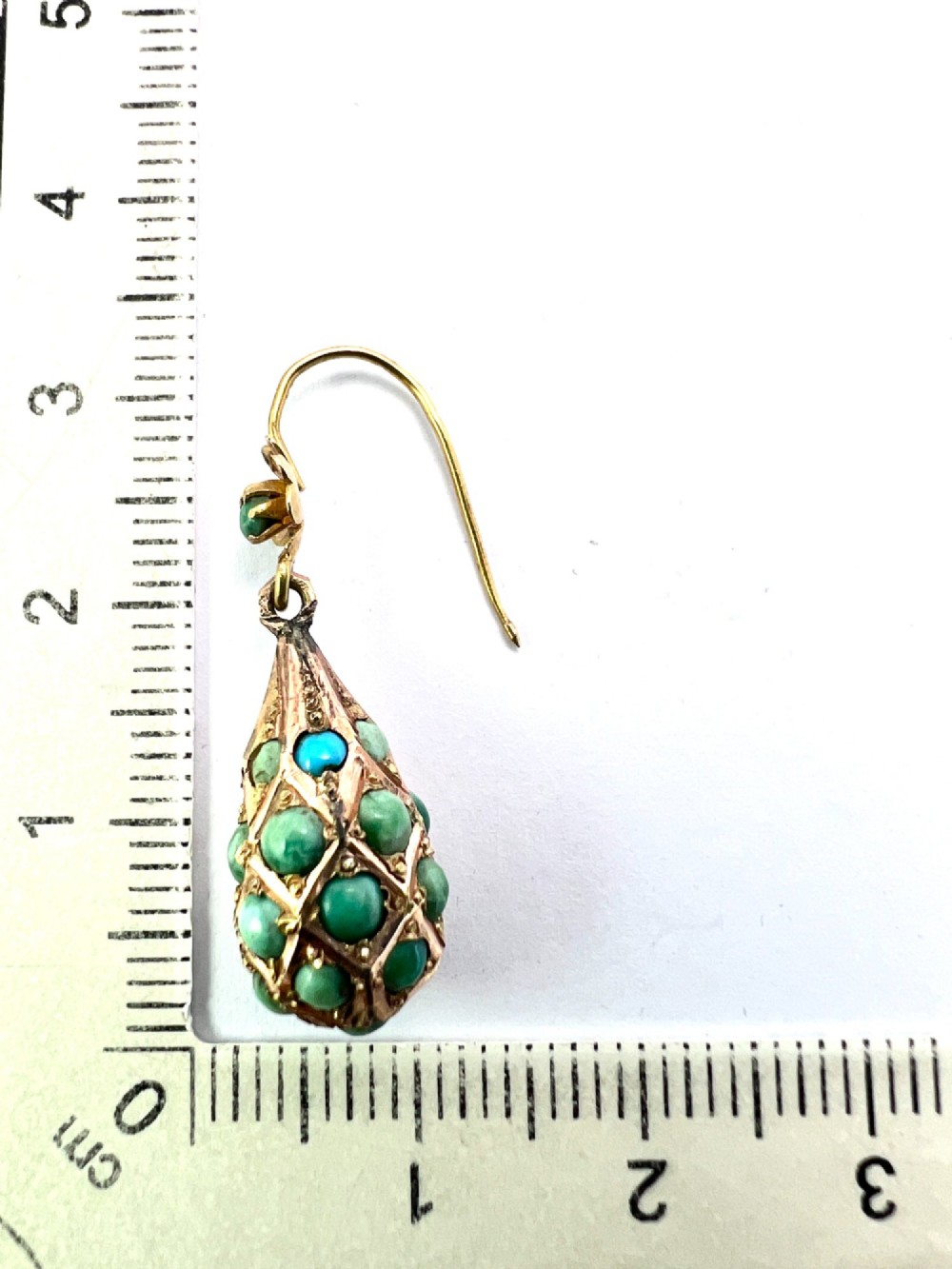 A pair of Victorian gold drop earrings featuring floral tops and lattice-engraved teardrop pendants set with turquoise cabochon stones. View VI