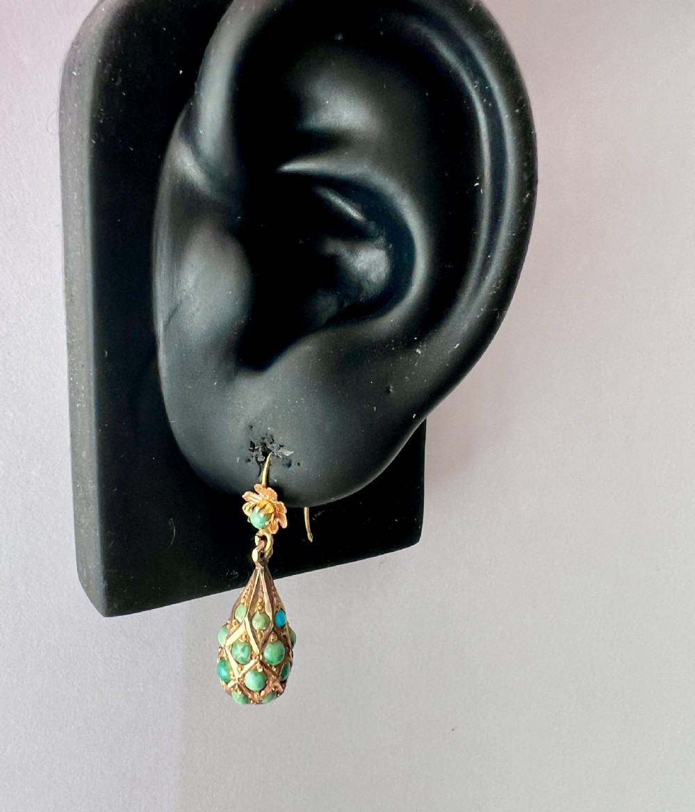 A pair of Victorian gold drop earrings featuring floral tops and lattice-engraved teardrop pendants set with turquoise cabochon stones. View VIII