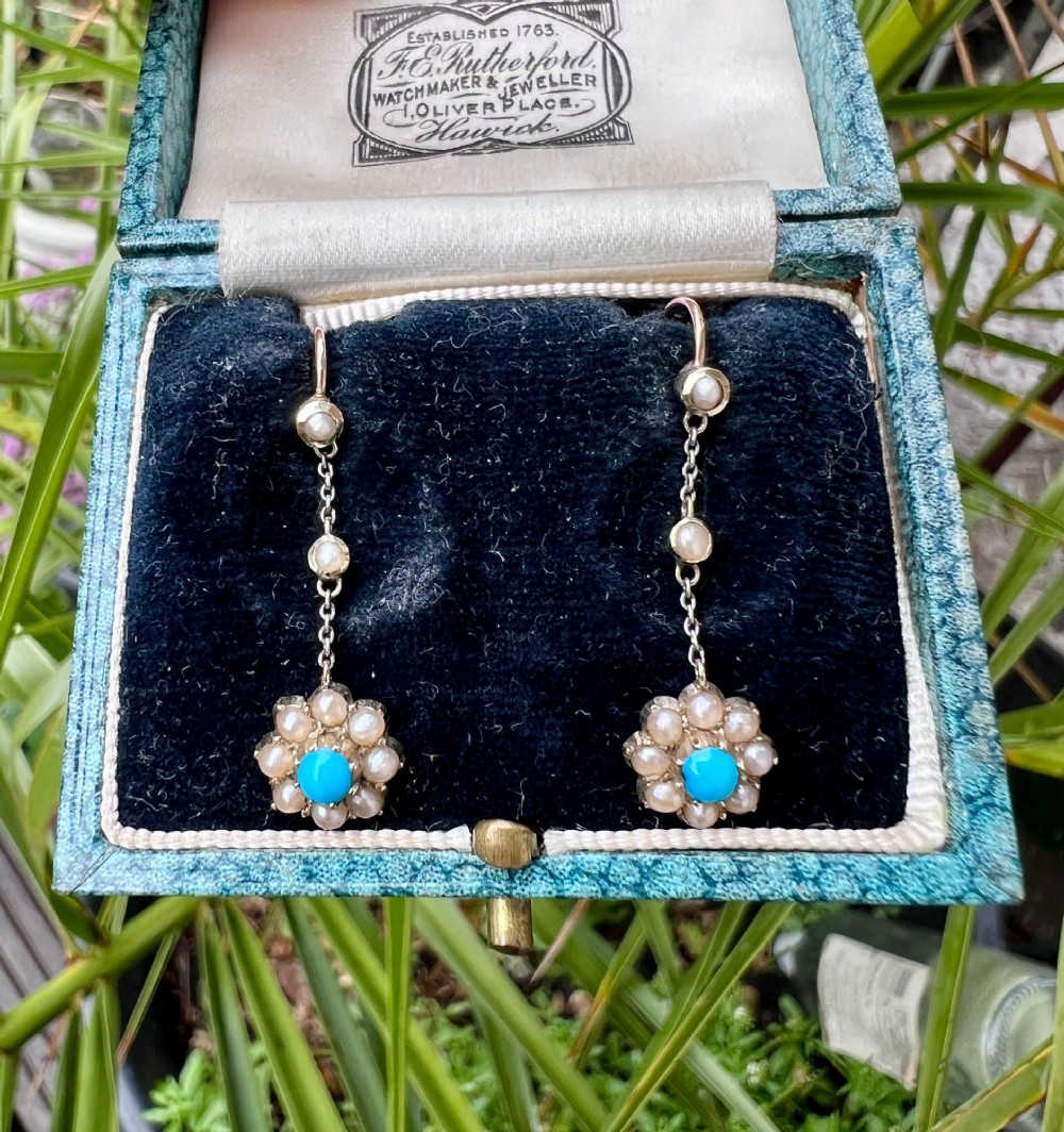 A pair of Edwardian gold drop earrings featuring floral cluster pendants set with central turquoise cabochons surrounded by pearls. View VIII
