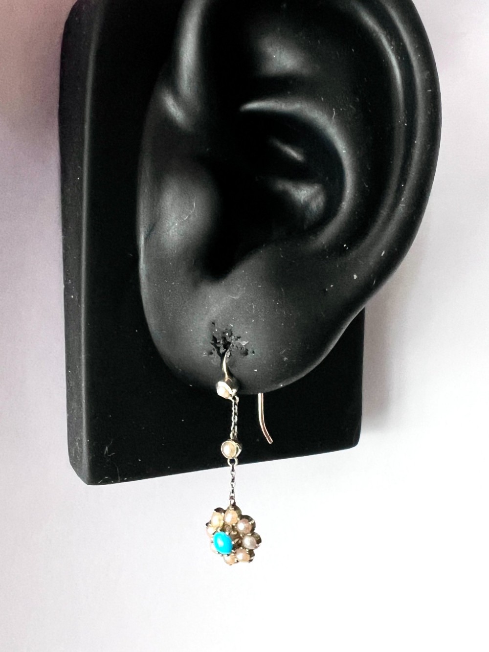 A pair of Edwardian gold drop earrings featuring floral cluster pendants set with central turquoise cabochons surrounded by pearls. View IX