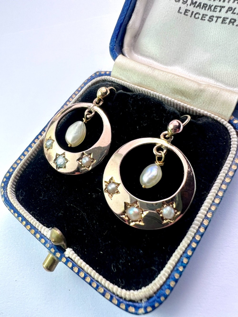 A pair of yellow gold Victorian crescent drop earrings featuring star-set seed pearls and a suspended central pearl drop. View V