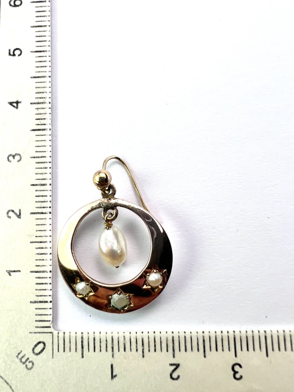 A pair of yellow gold Victorian crescent drop earrings featuring star-set seed pearls and a suspended central pearl drop. View VI