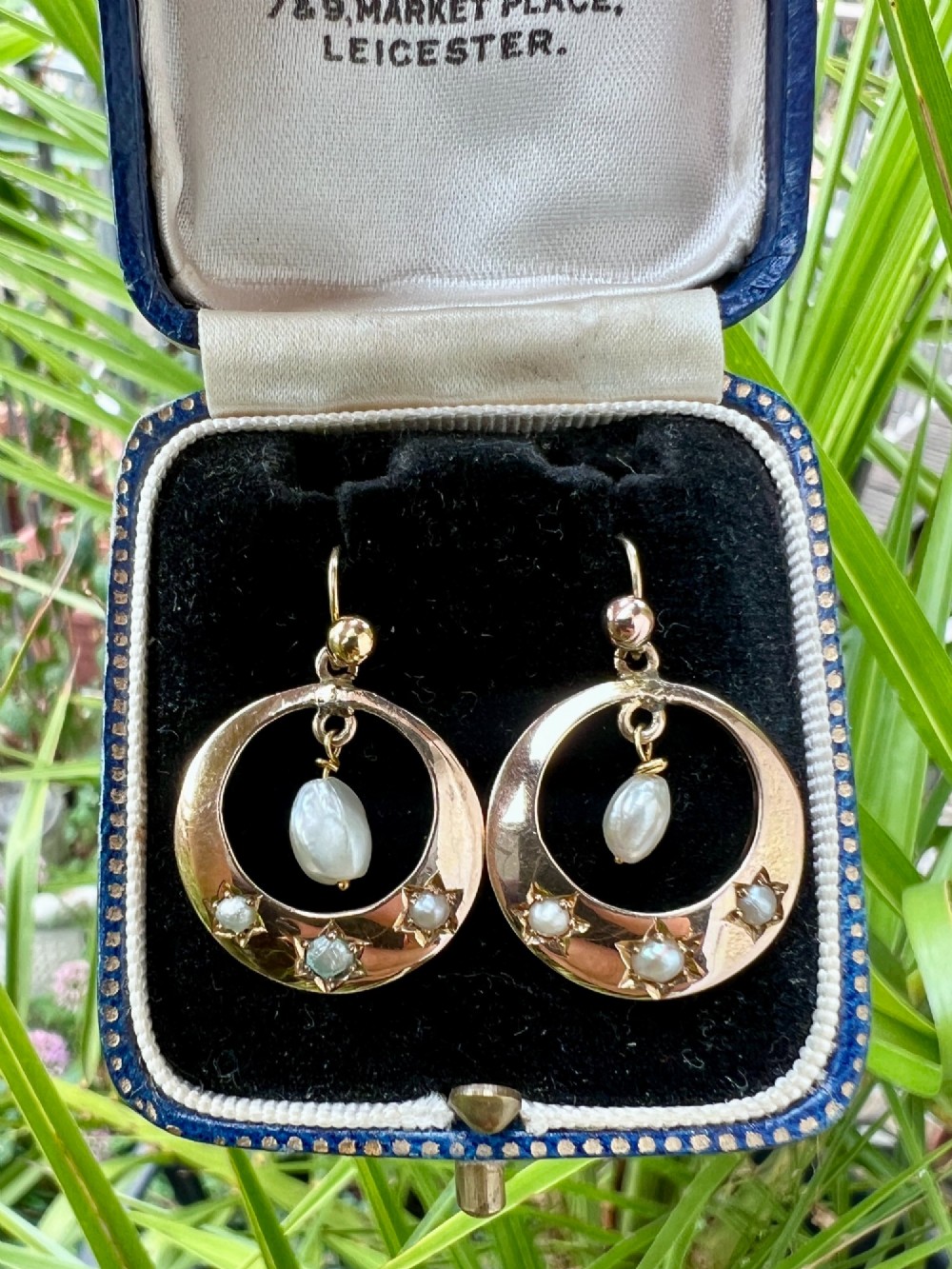 A pair of yellow gold Victorian crescent drop earrings featuring star-set seed pearls and a suspended central pearl drop. View VII