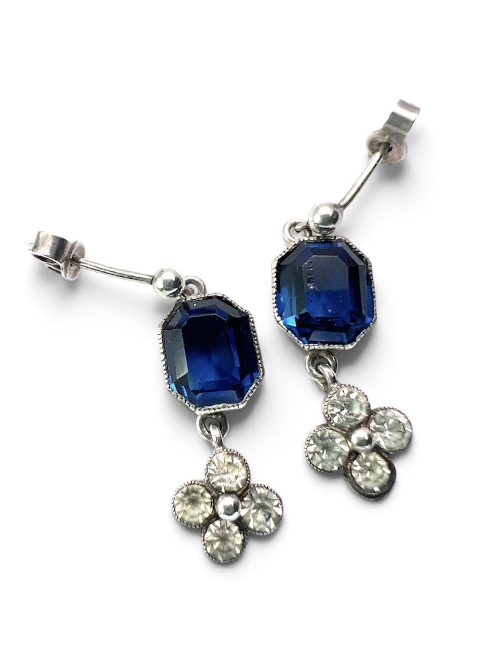 An Art Deco silver jewellery set comprising a link necklace and drop earrings with octagonal blue paste stones and clear cluster links. View V