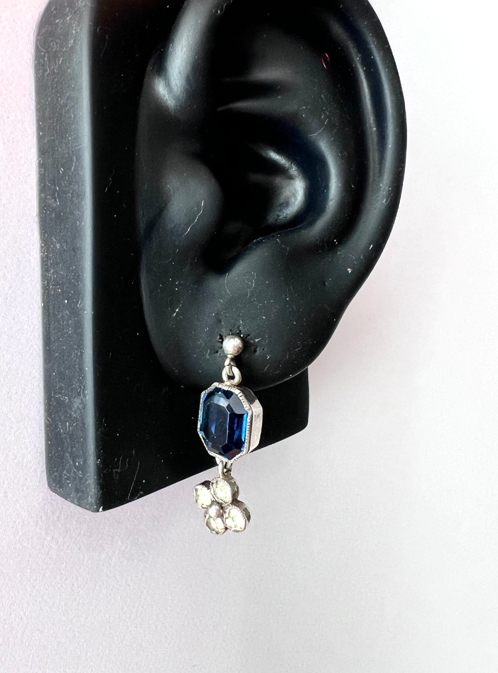 An Art Deco silver jewellery set comprising a link necklace and drop earrings with octagonal blue paste stones and clear cluster links. View VIII