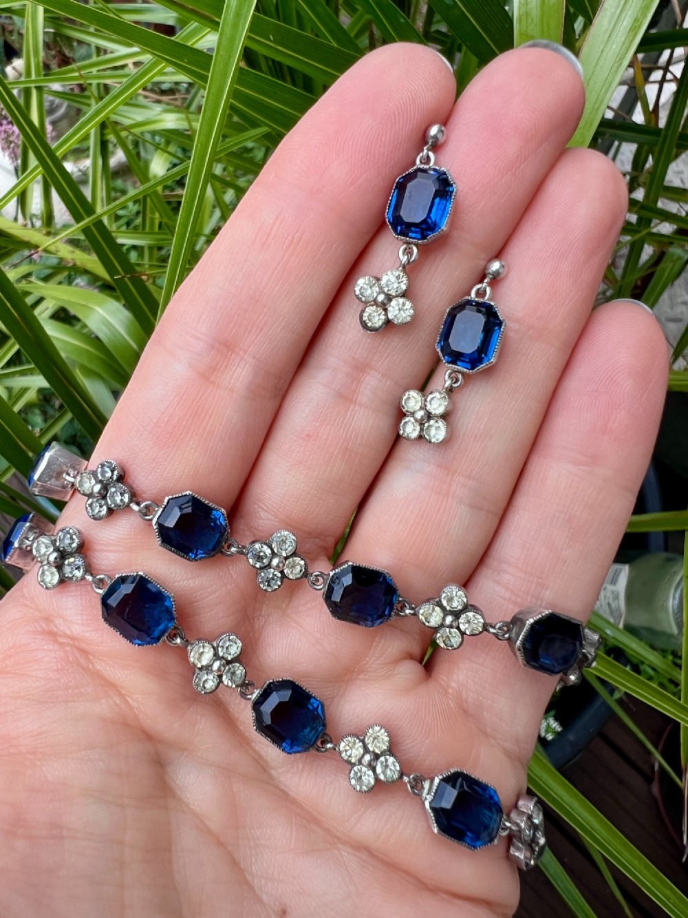 An Art Deco silver jewellery set comprising a link necklace and drop earrings with octagonal blue paste stones and clear cluster links. View IX