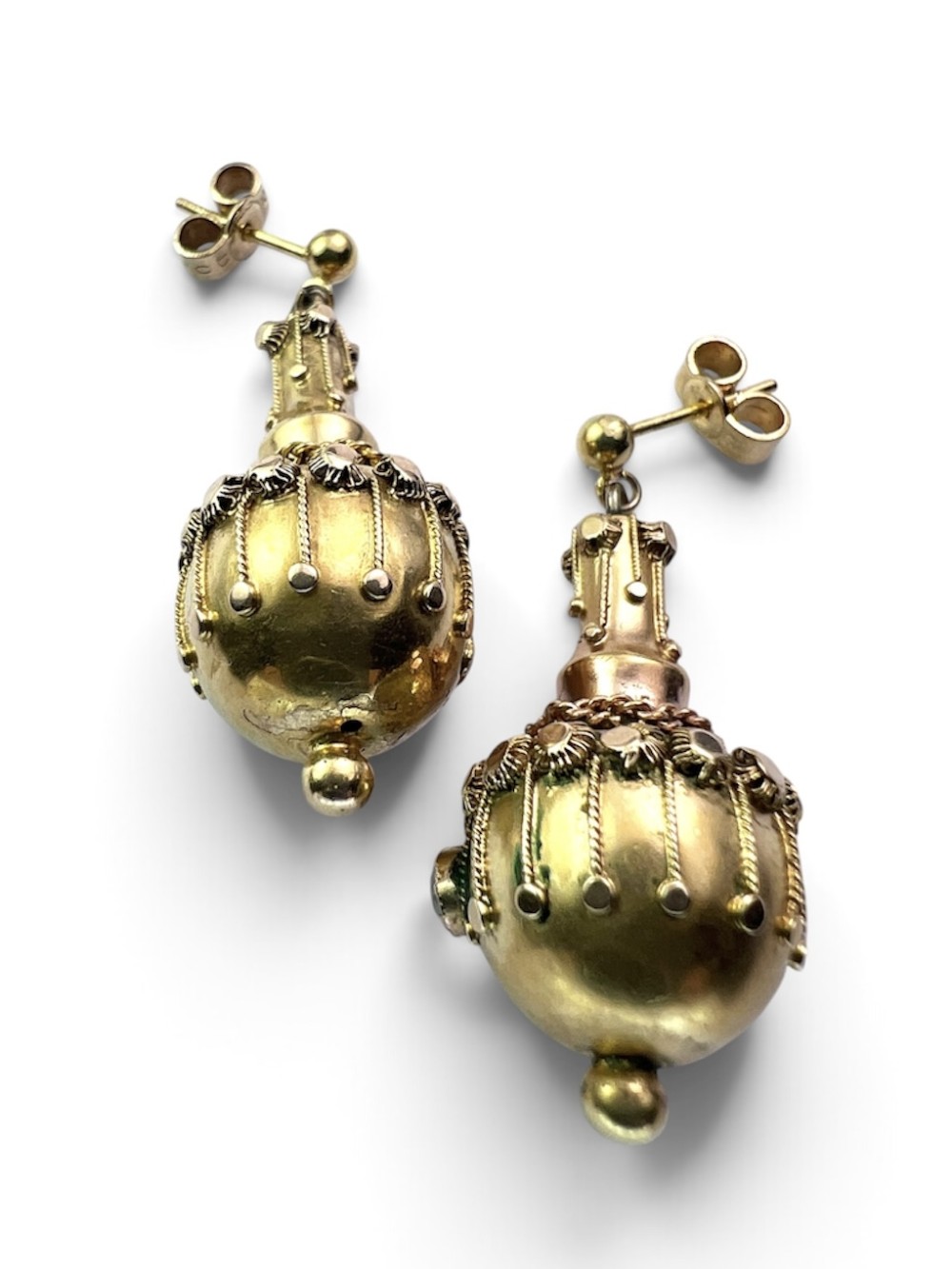 A pair of Victorian 15ct yellow gold Etruscan Revival drop earrings featuring amphora-shaped pendants embellished with granulation wirework and central gemstones. View V