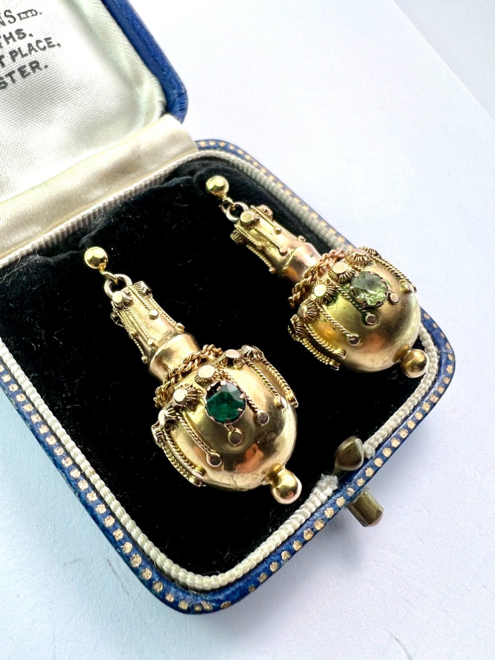A pair of Victorian 15ct yellow gold Etruscan Revival drop earrings featuring amphora-shaped pendants embellished with granulation wirework and central gemstones. View VII