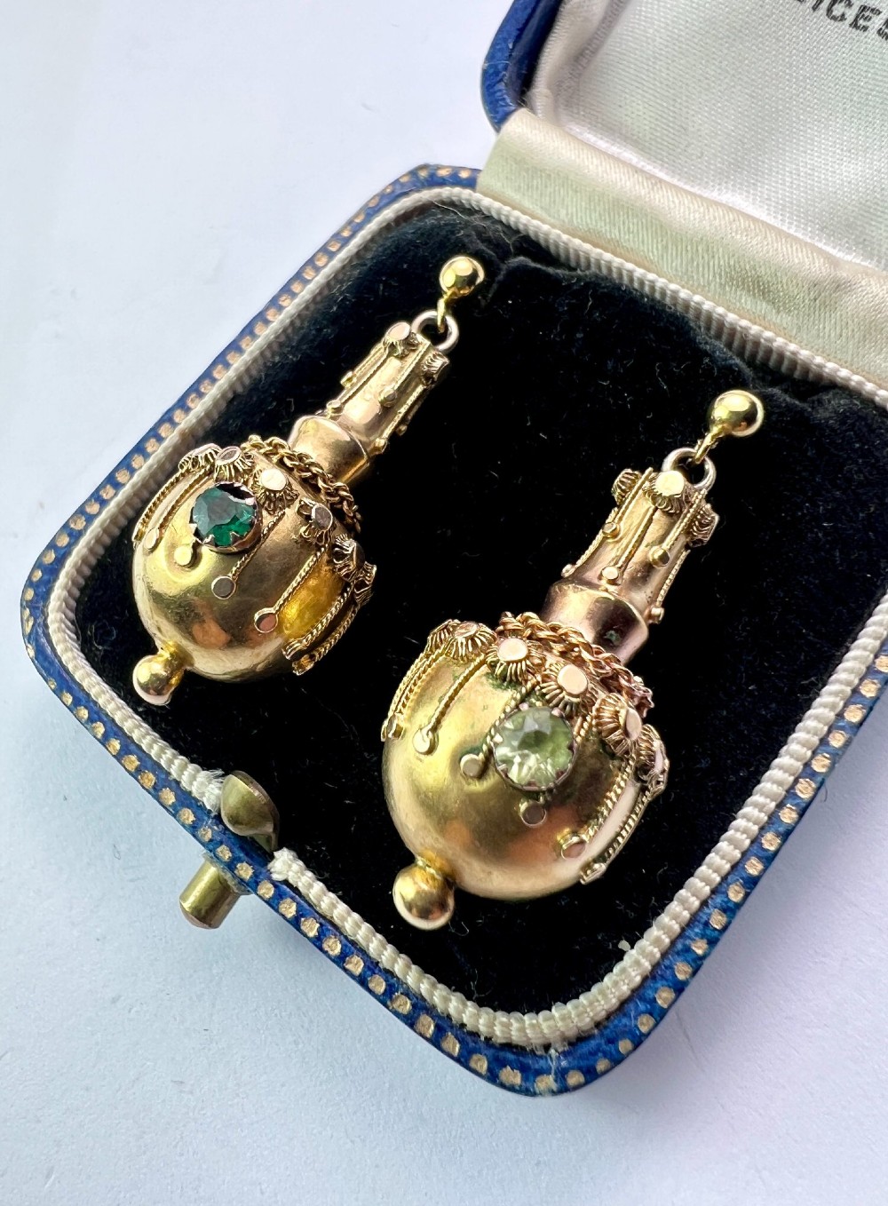 A pair of Victorian 15ct yellow gold Etruscan Revival drop earrings featuring amphora-shaped pendants embellished with granulation wirework and central gemstones. View VIII