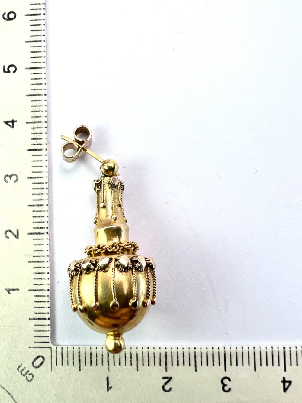A pair of Victorian 15ct yellow gold Etruscan Revival drop earrings featuring amphora-shaped pendants embellished with granulation wirework and central gemstones. View IX