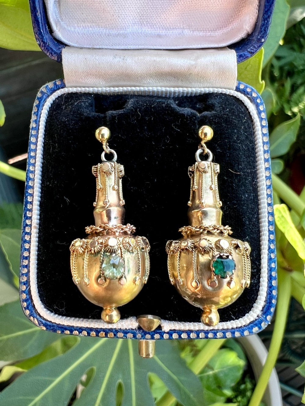 A pair of Victorian 15ct yellow gold Etruscan Revival drop earrings featuring amphora-shaped pendants embellished with granulation wirework and central gemstones. View X