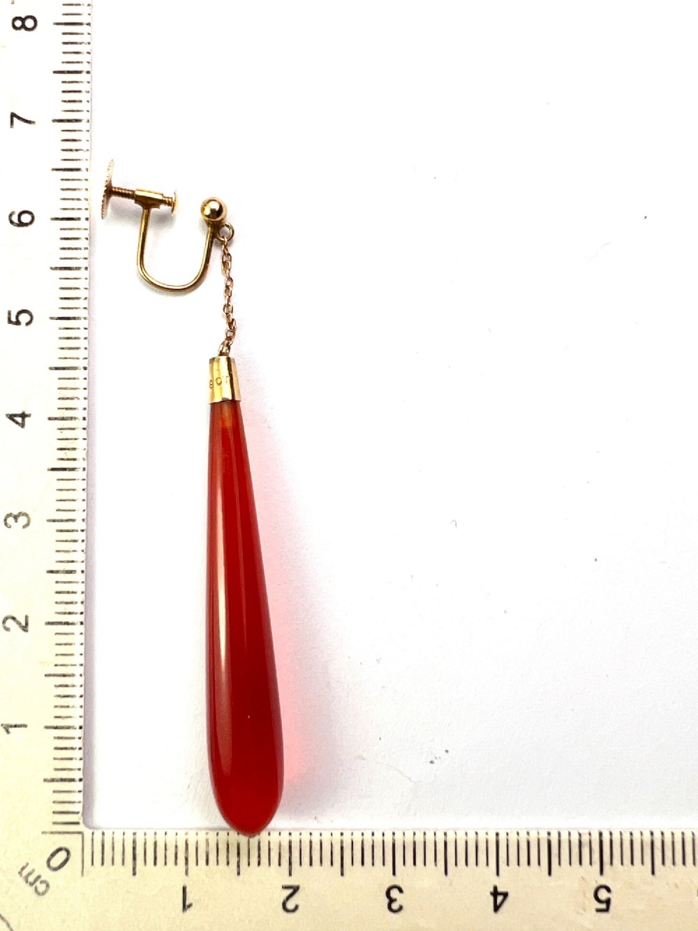 A pair of antique Edwardian drop earrings featuring long, polished teardrop-shaped carnelian stones suspended from delicate 9ct gold chains. View VI