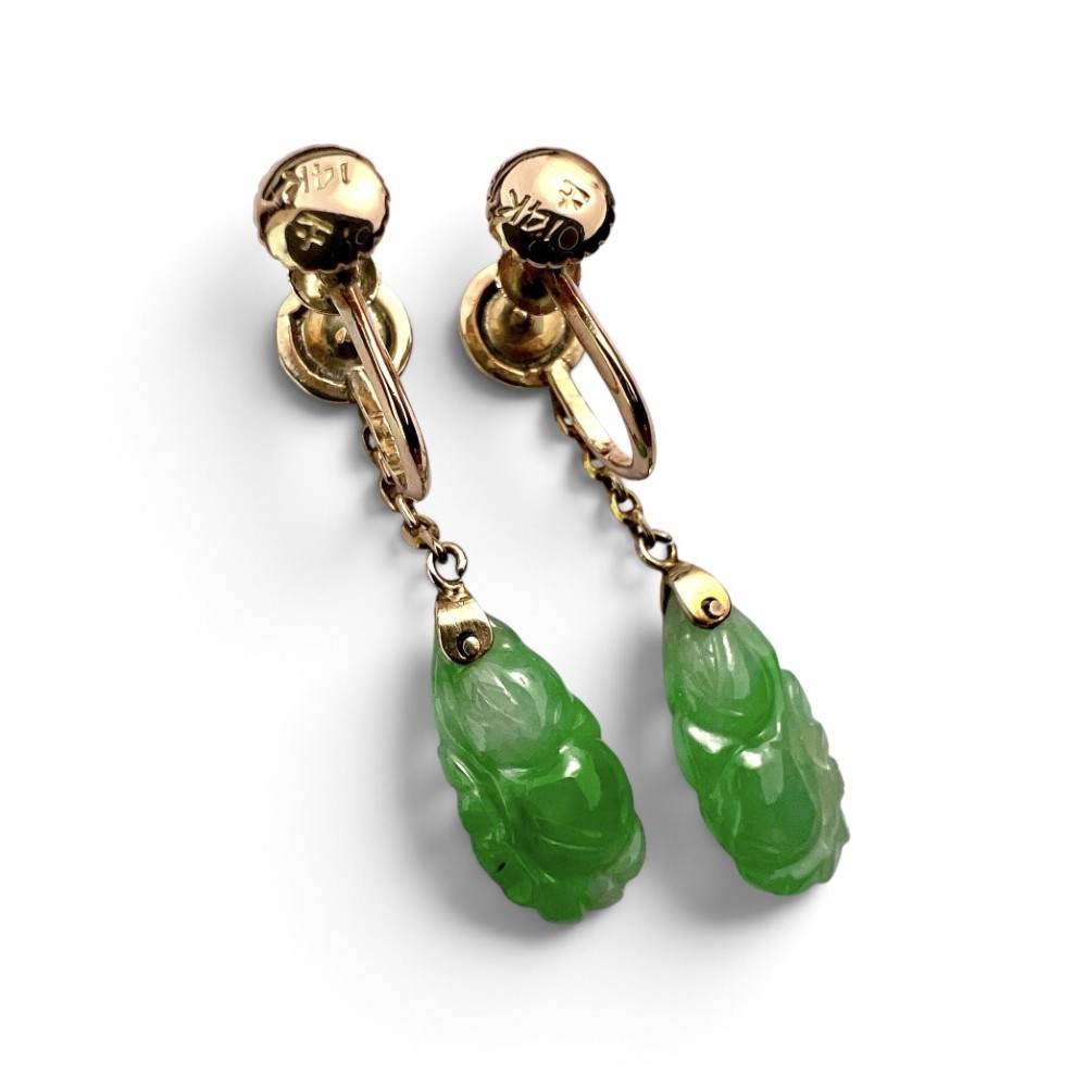 A pair of Art Deco 14ct gold drop earrings featuring circular green jade cabochons at the top connected by short chain links to teardrop-shaped carved green jade pendants. View IV