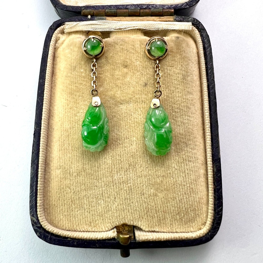 A pair of Art Deco 14ct gold drop earrings featuring circular green jade cabochons at the top connected by short chain links to teardrop-shaped carved green jade pendants. View VI