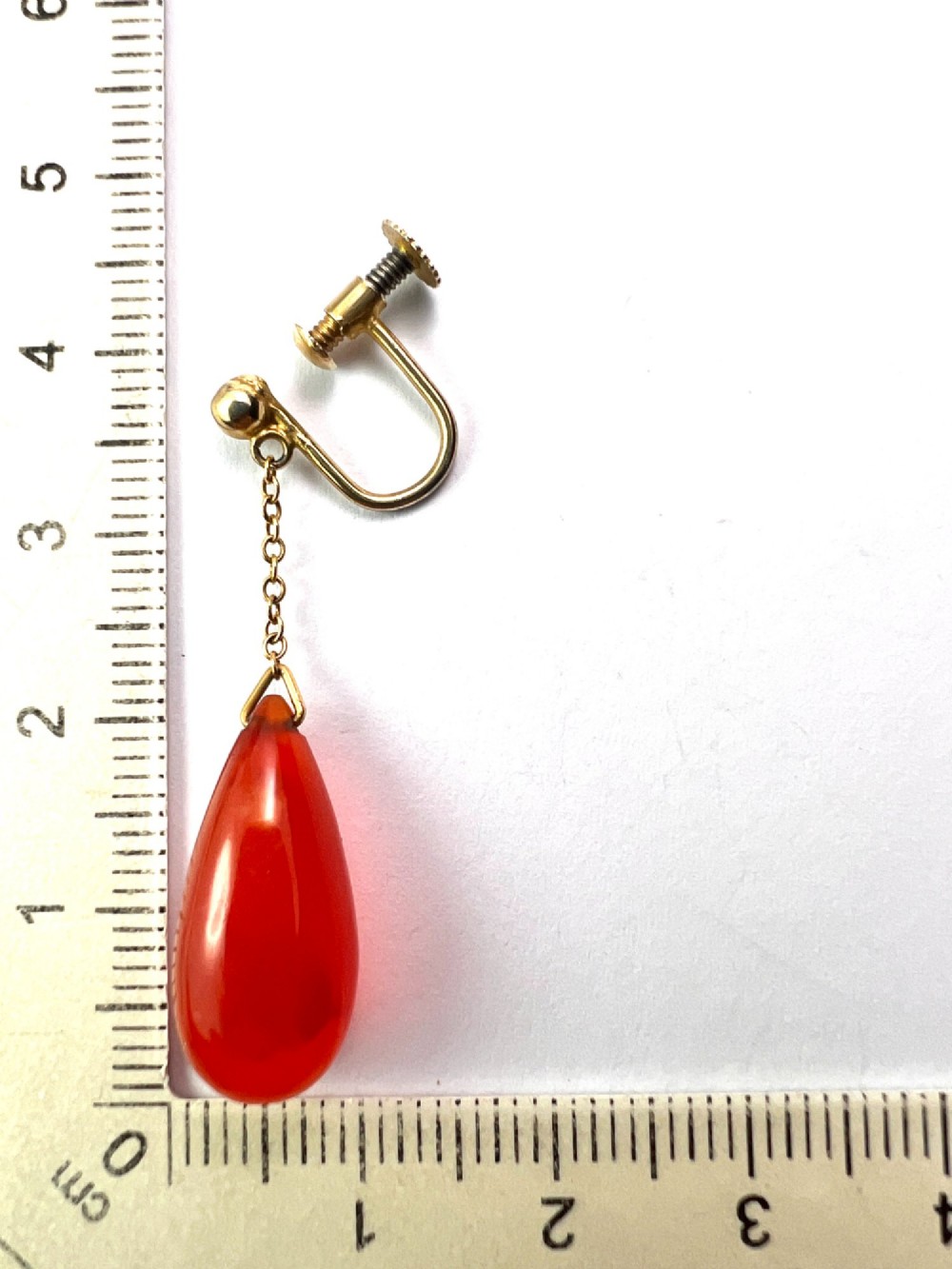 Pair of Edwardian 9ct gold screw-back earrings featuring delicate chains suspending polished teardrop-shaped red agate drops. View V