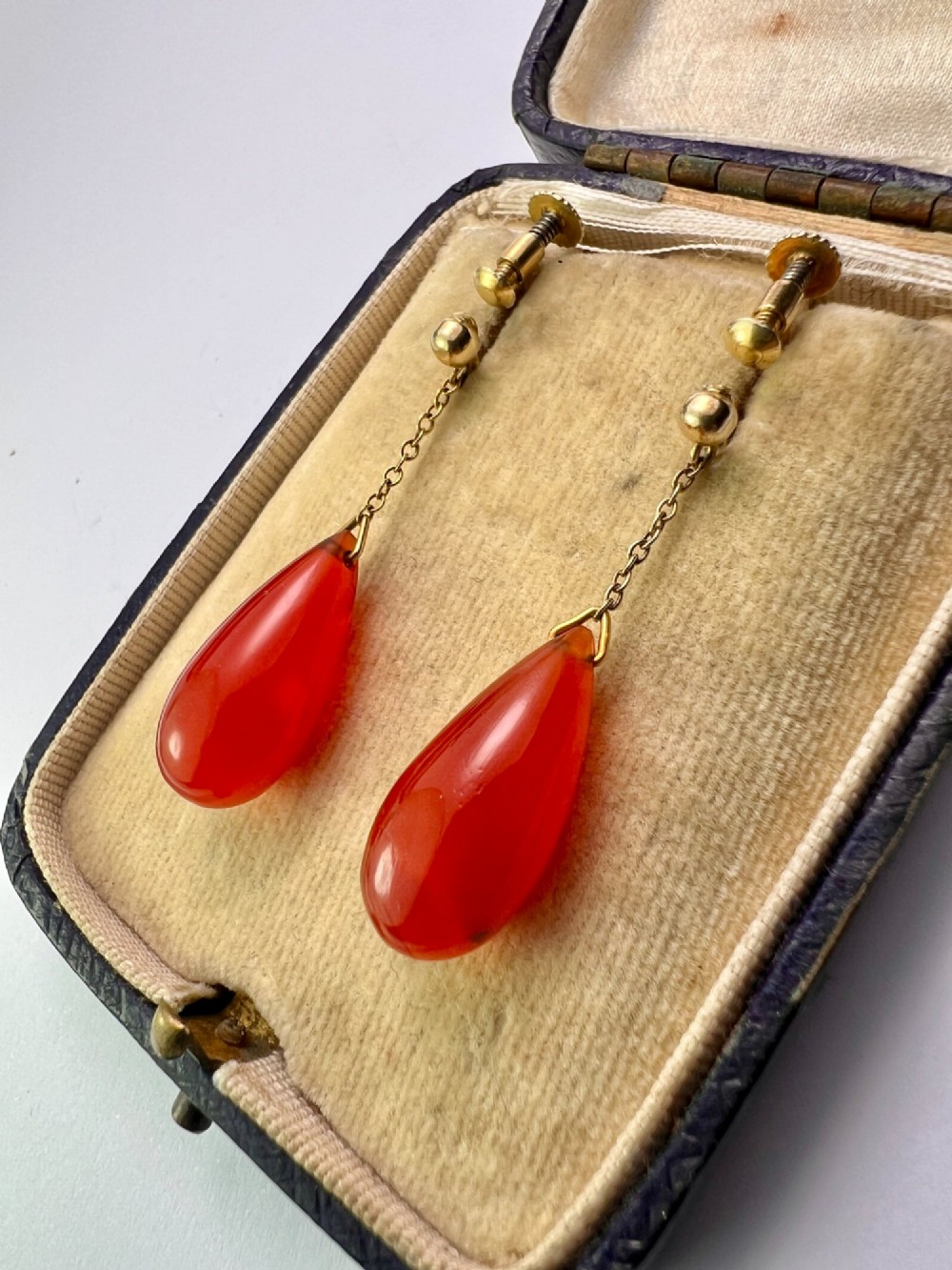 Pair of Edwardian 9ct gold screw-back earrings featuring delicate chains suspending polished teardrop-shaped red agate drops. View VII
