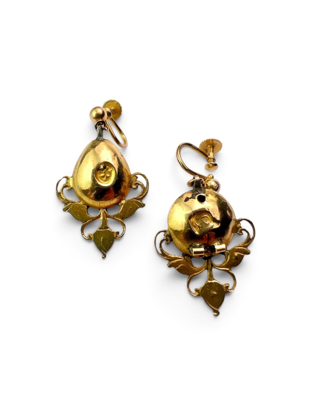 A pair of ornate Georgian yellow gold drop earrings featuring central step-cut green gemstones surrounded by smaller accent stones and scrollwork flourishes. View III