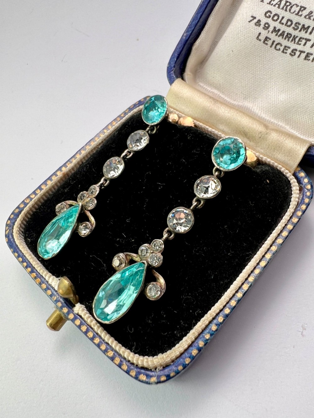 A pair of Victorian gold and silver drop earrings set with light blue and clear paste stones. View V