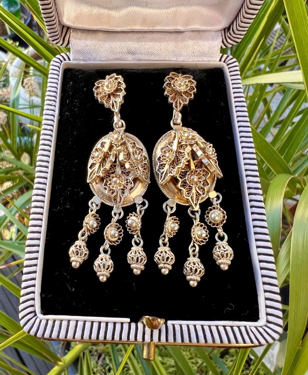 A pair of Victorian gilded silver filigree girandole chandelier earrings with triple dangling drops, displayed inside a velvet presentation box. View VIII